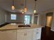 Bright kitchen featuring an island with white cabinets and granite countertops in an open layout at 15747 Sw 47Th Avenue Rd, Ocala, FL 34473