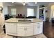 Kitchen island featuring granite countertop, stainless steel sink, dishwasher, and white cabinets at 15747 Sw 47Th Avenue Rd, Ocala, FL 34473