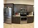 Updated kitchen featuring stainless steel appliances, granite countertops, and dark wood cabinets at 15747 Sw 47Th Avenue Rd, Ocala, FL 34473