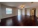 Spacious living room with dark wood floors, ceiling fan, and natural light creates a welcoming atmosphere at 15747 Sw 47Th Avenue Rd, Ocala, FL 34473