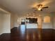Open-concept living room featuring dark hardwood floors connecting to a modern kitchen at 15747 Sw 47Th Avenue Rd, Ocala, FL 34473
