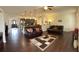 Spacious living room with hardwood floors seamlessly connected to kitchen and dining areas at 15747 Sw 47Th Avenue Rd, Ocala, FL 34473