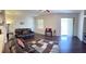 Open-concept living room with hardwood floors, natural light, and comfortable seating arrangement at 15747 Sw 47Th Avenue Rd, Ocala, FL 34473