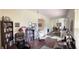 Inviting office area featuring hardwood floors, natural light, book shelves, and a comfortable seating at 15747 Sw 47Th Avenue Rd, Ocala, FL 34473