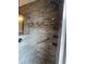 Walk-in shower with handrails, bench, rainfall shower head, and tiled walls at 15747 Sw 47Th Avenue Rd, Ocala, FL 34473