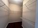 Spacious walk-in closet with wire shelving and dark wood flooring at 15747 Sw 47Th Avenue Rd, Ocala, FL 34473
