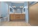 Bathroom with a double sink vanity, a large mirror, a shower, and a toilet at 8655 Sw 86Th Cir, Ocala, FL 34481