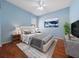 This staged bedroom features hardwood floors, a painting, a bed, and some furniture at 8655 Sw 86Th Cir, Ocala, FL 34481