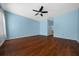 Large bedroom with hardwood floors, ceiling fan and blue walls at 8655 Sw 86Th Cir, Ocala, FL 34481