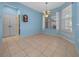 A dining room with neutral tile flooring and a window with lots of natural light at 8655 Sw 86Th Cir, Ocala, FL 34481