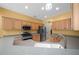 Full kitchen with stainless steel appliances, light wood cabinets, and yellow walls at 8655 Sw 86Th Cir, Ocala, FL 34481