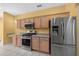 Bright kitchen with stainless steel appliances and light wooden cabinets at 8655 Sw 86Th Cir, Ocala, FL 34481