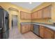 Kitchen with stainless steel appliances, light wood cabinets, and an archway leading to another room at 8655 Sw 86Th Cir, Ocala, FL 34481
