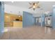 Open-concept living area featuring tile flooring, blue and yellow accent walls, and natural lighting at 8655 Sw 86Th Cir, Ocala, FL 34481