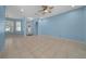 Bright living room features neutral tile flooring, blue accent wall, and a front door at 8655 Sw 86Th Cir, Ocala, FL 34481