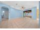 Spacious living room with tile flooring, an open doorway, and sliding glass doors at 8655 Sw 86Th Cir, Ocala, FL 34481