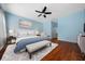Stylishly furnished main bedroom with hardwood floors, ceiling fan, and ensuite bathroom at 8655 Sw 86Th Cir, Ocala, FL 34481