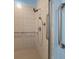 Bathroom with white tile shower, shower head, and grab bars at 8655 Sw 86Th Cir, Ocala, FL 34481