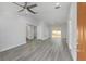 Open-concept living room with gray vinyl floors, a modern ceiling fan, and abundant natural light at 2564 Sw 157 Ct, Ocala, FL 34481