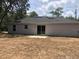 Exterior view of the home's back facade and patio, showing the backyard at 6 Fisher Way Pl, Ocklawaha, FL 32179