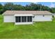 Rear view of house with screened porch and expansive lawn at 6248 Sw 103Rd Street Rd, Ocala, FL 34476