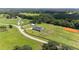 Aerial view of a home on a large lot with horse stables and riding arena at 11098 Nw 50Th Ln, Ocala, FL 34482