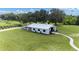 White barn with a metal roof and multiple stalls at 11098 Nw 50Th Ln, Ocala, FL 34482