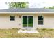 View of the patio with sliding glass doors leading into the home and a gray roofline at 1 Pine Trace Trl, Ocala, FL 34472