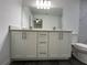 Bathroom with white vanity, double sinks, and grey vinyl flooring at 1 Pine Trace Trl, Ocala, FL 34472