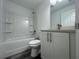 Bathroom with tub/shower combo, white vanity, and grey vinyl flooring at 1 Pine Trace Trl, Ocala, FL 34472