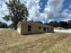 Back exterior of tan house, showing sliding glass doors at 1 Pine Trace Trl, Ocala, FL 34472