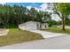 Tan house with two car garage and landscaped yard at 1 Pine Trace Trl, Ocala, FL 34472