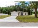 Newly built home with a gray garage door and a small lawn at 1 Pine Trace Trl, Ocala, FL 34472