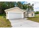 White garage door with a concrete driveway at 1 Pine Trace Trl, Ocala, FL 34472