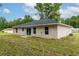 Tan house with windows and a sliding glass door at 1 Pine Trace Trl, Ocala, FL 34472