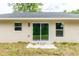 New home with sliding glass door and small patio at 1 Pine Trace Trl, Ocala, FL 34472