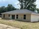 Rear exterior view of a new home showcasing ample windows and doors for natural light and outdoor access at 1 Pine Trace Trl, Ocala, FL 34472