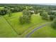 Aerial view of property showcasing expansive green space and a long driveway at 2291 Sw 76Th Ln, Ocala, FL 34476