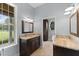 Double vanity bathroom with granite countertop and large mirror at 2291 Sw 76Th Ln, Ocala, FL 34476