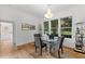 Bright dining room with a glass table, gray chairs, and views to the backyard at 2291 Sw 76Th Ln, Ocala, FL 34476