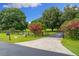 Landscaped front yard with a long driveway and a black fence at 2291 Sw 76Th Ln, Ocala, FL 34476