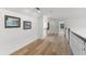 Upstairs hallway with hardwood floors and artwork at 2291 Sw 76Th Ln, Ocala, FL 34476