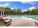 Inviting kidney-shaped pool with a spacious patio and lounge chairs at 2291 Sw 76Th Ln, Ocala, FL 34476