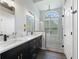 Bright bathroom with dual sinks, frameless shower and arched window at 11831 Sw Highway 484, Dunnellon, FL 34432