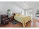 Bright main bedroom features vaulted ceiling, ceiling fan, wood floors and a side chair at 11831 Sw Highway 484, Dunnellon, FL 34432