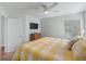 Bedroom with wood floors, ceiling fan, mounted tv and a large window for lots of light at 11831 Sw Highway 484, Dunnellon, FL 34432
