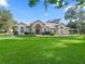 Beautiful home with lush lawn, featuring a symmetrical elevation and welcoming entryway at 11831 Sw Highway 484, Dunnellon, FL 34432