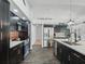 Modern kitchen with stainless steel appliances, dark cabinets, and an island with a white countertop at 11831 Sw Highway 484, Dunnellon, FL 34432