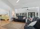 Open-concept living room with hardwood floors, ceiling fan and access to a bedroom at 11831 Sw Highway 484, Dunnellon, FL 34432