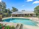 Backyard pool featuring a spa and an expansive concrete deck, perfect for outdoor relaxation and entertaining at 11831 Sw Highway 484, Dunnellon, FL 34432